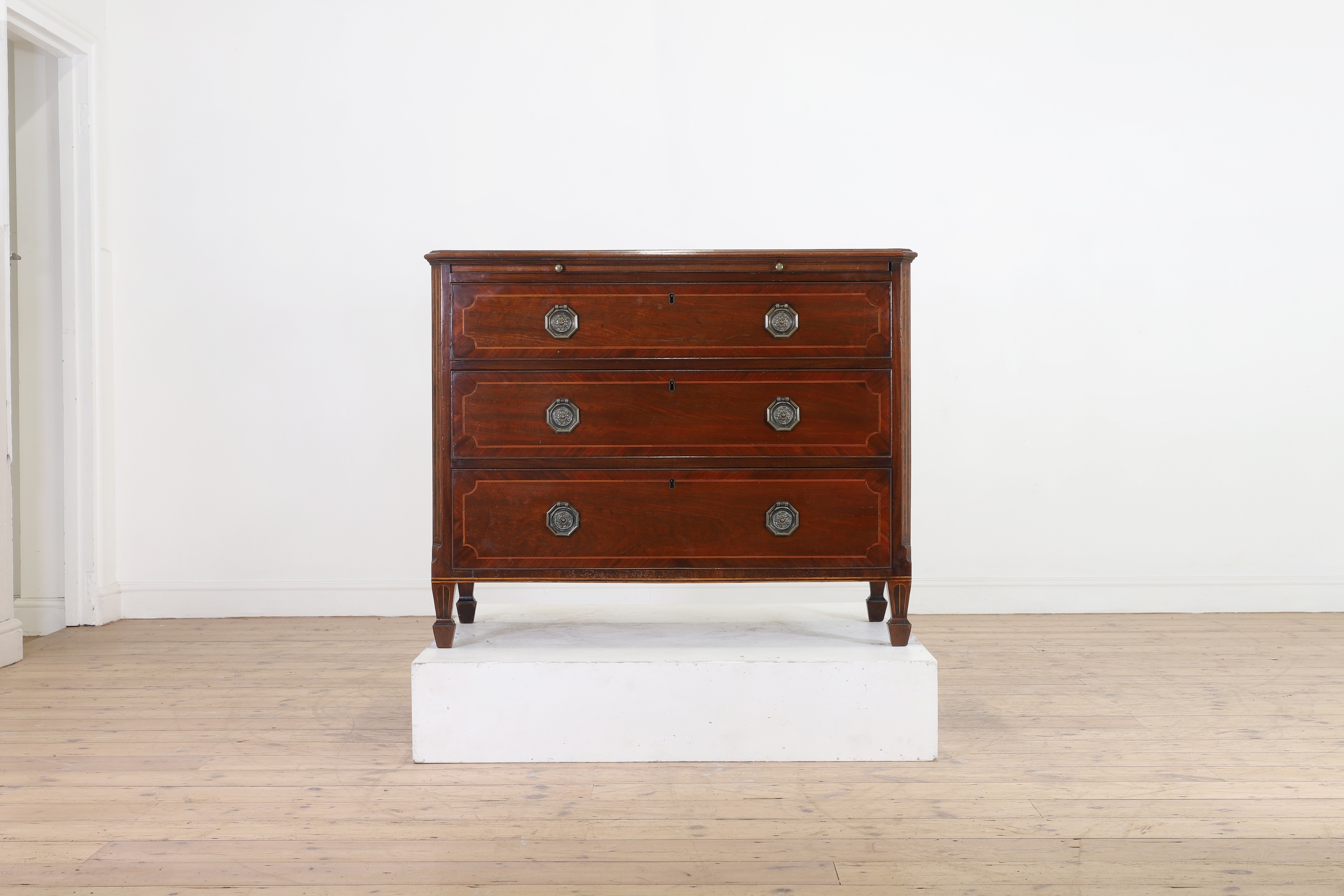 A George III mahogany chest of drawers by Gillows, c.1790, the moulded rectangular top above a brushing slide and three drawers, raised on tapering square supports terminating in spade feet, stamped to the drawer (£2,000-3,000)